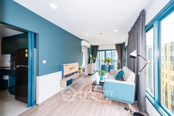 Modern living room with stylish decor and large windows for natural light.