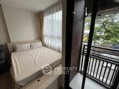 Cozy bedroom with balcony view in modern apartment