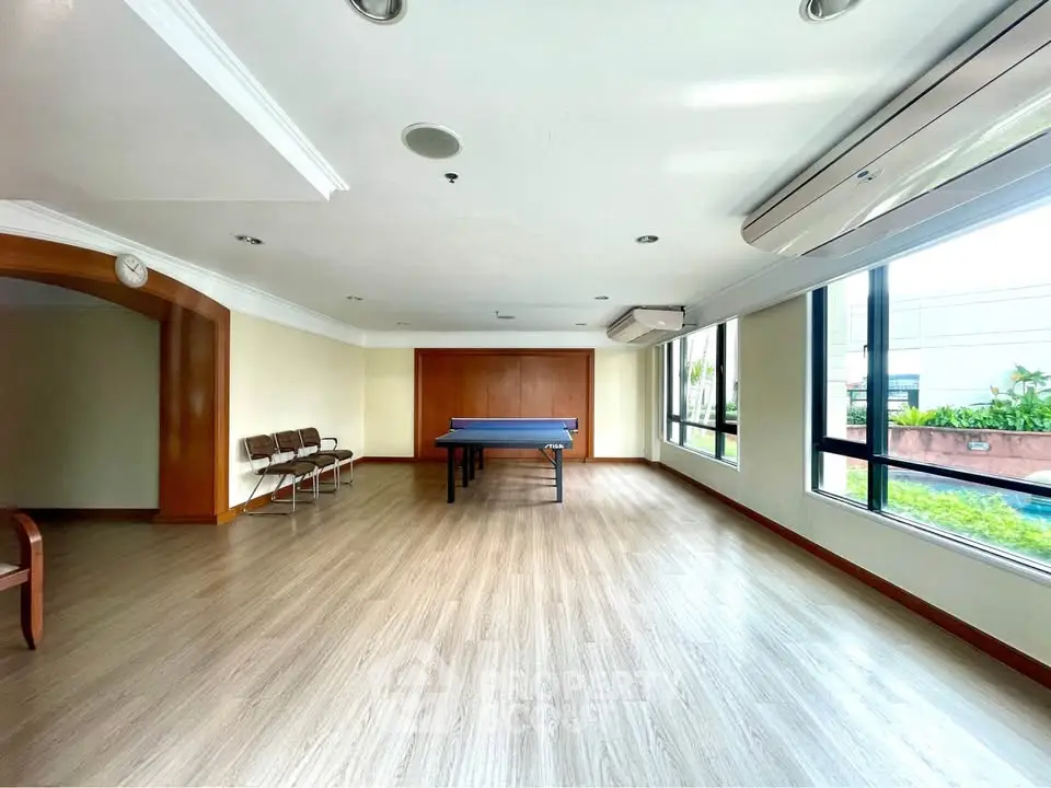 Spacious recreation room with table tennis and large windows in modern building