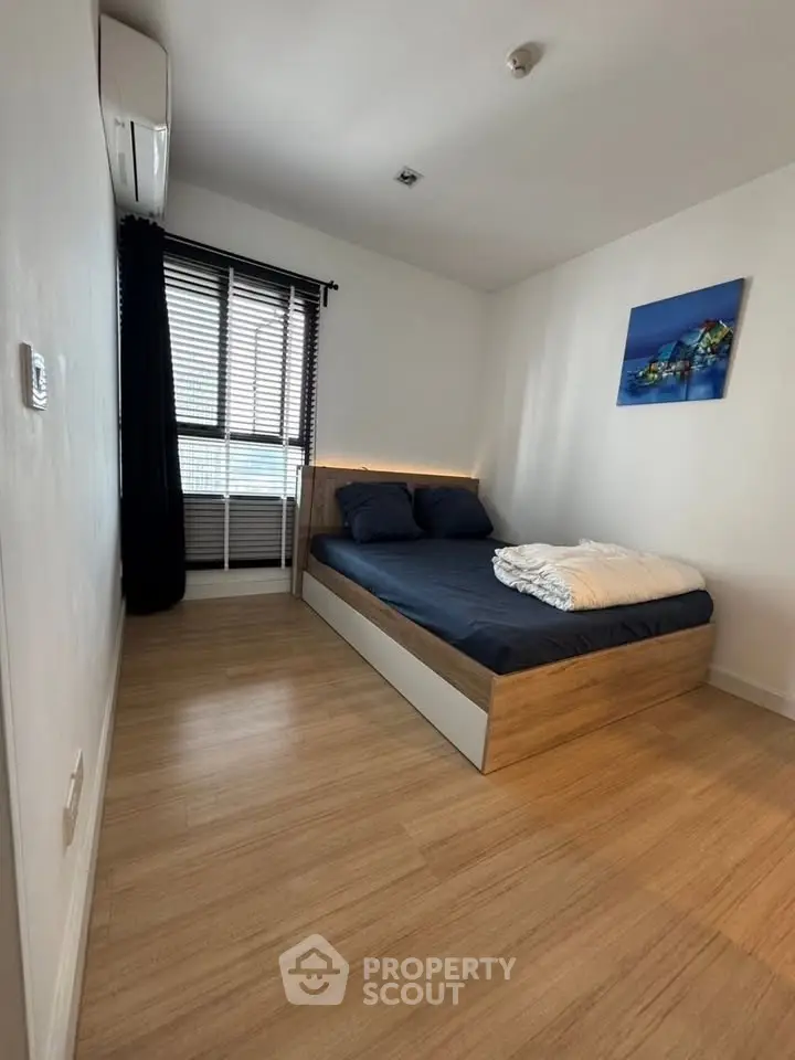 Modern bedroom with wooden flooring and stylish decor