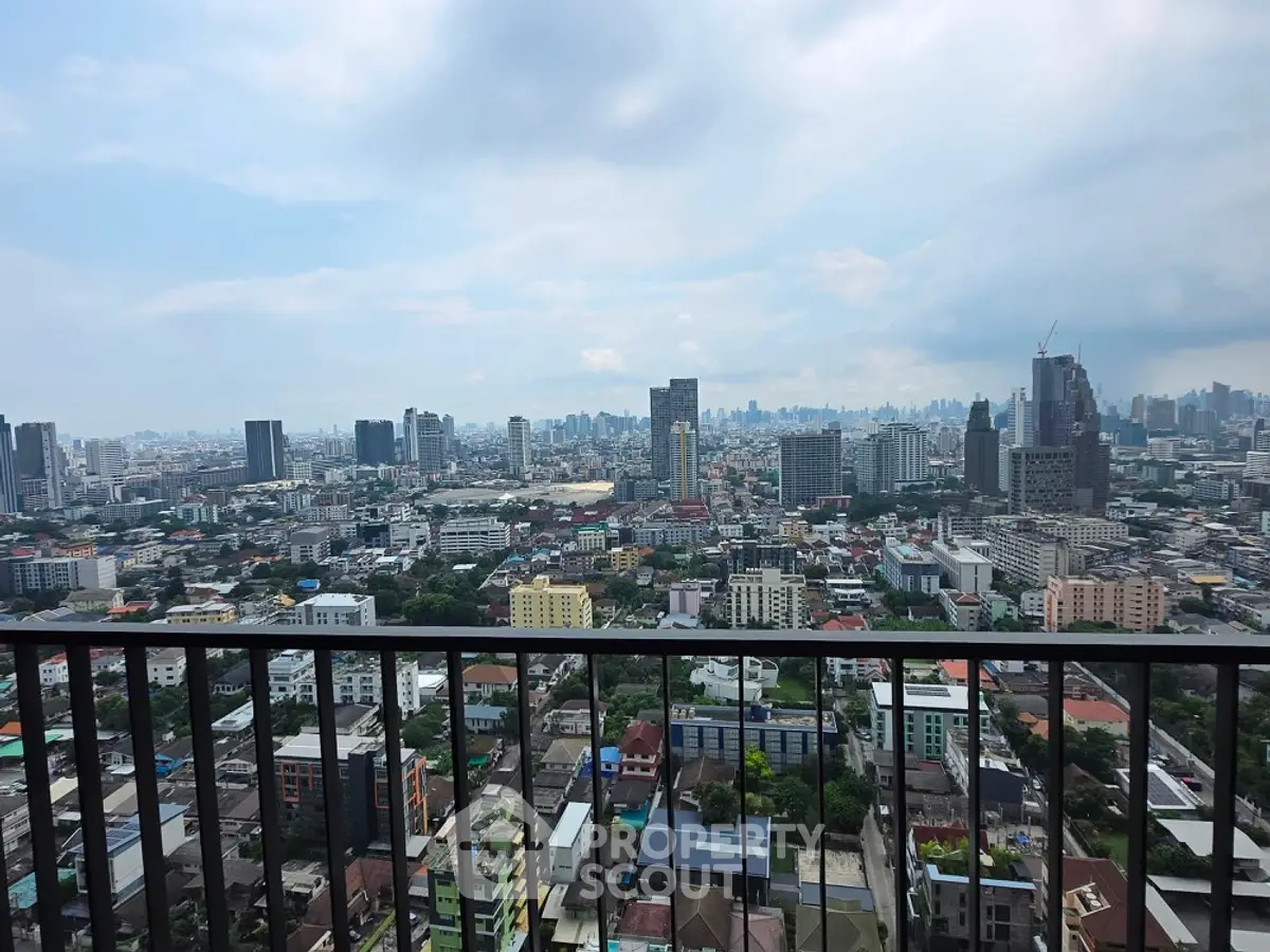 Stunning cityscape view from a high-rise balcony overlooking urban skyline.