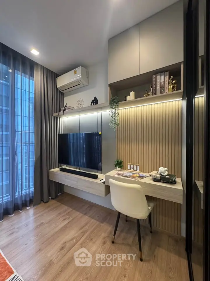 Modern living room with stylish decor and built-in TV unit, featuring elegant wood flooring and ambient lighting.