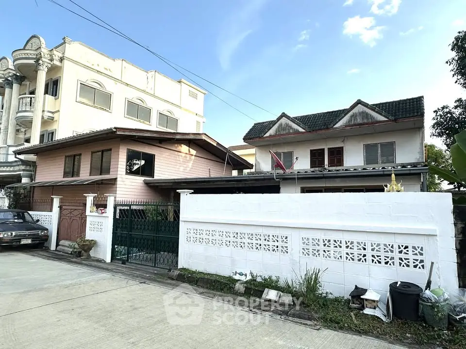 Charming residential houses with unique architectural styles in a serene neighborhood setting.