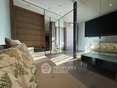 Modern living room with elegant decor and large mirror wall