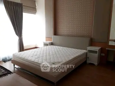 Spacious bedroom with elegant decor and natural light