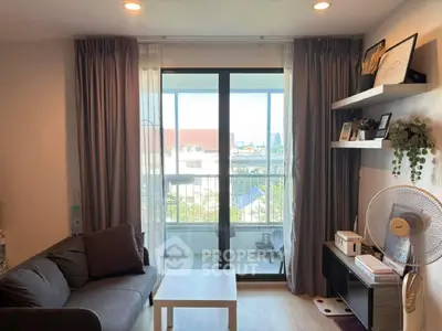 Cozy living room with balcony view, modern decor, and ample natural light
