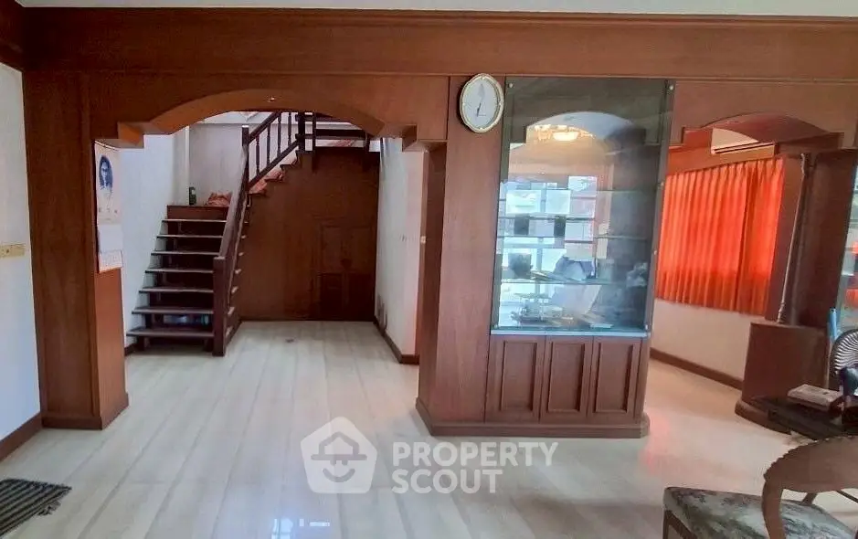 Spacious interior with wooden accents and staircase, ideal for cozy living.