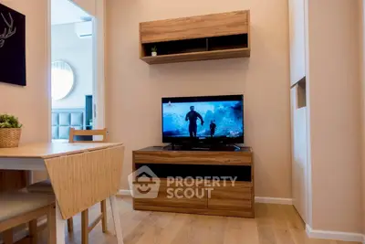 Cozy living room with modern wooden furniture and TV, perfect for relaxation.