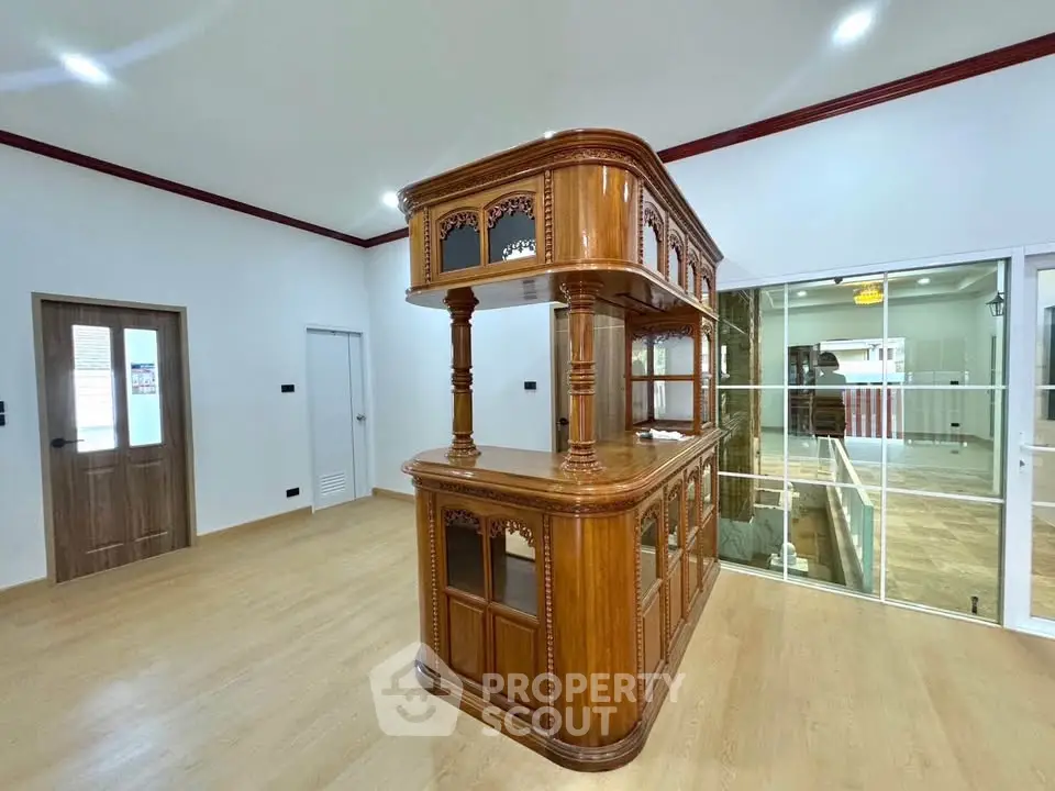 Spacious interior with elegant wooden bar and modern glass doors, perfect for entertaining.