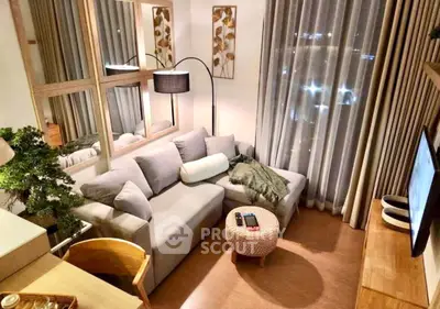 Cozy living room with modern decor and large windows for natural light.