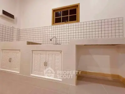 Modern kitchen with sleek white cabinetry and tiled backsplash