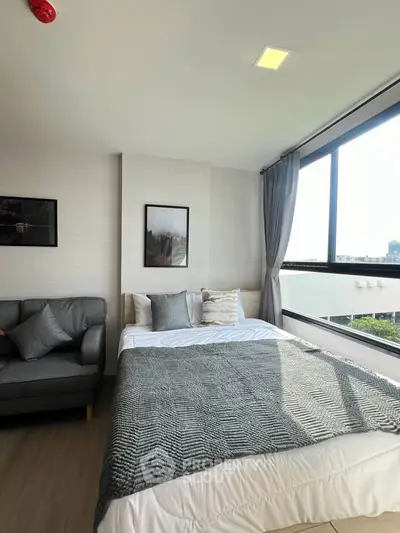 Bright and cozy bedroom with large window and modern decor