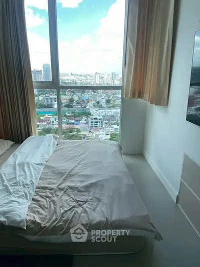 Modern bedroom with stunning city view from large window, featuring cozy bed and elegant curtains.