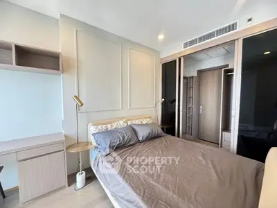 Modern bedroom with stylish decor and ample storage in a contemporary apartment.