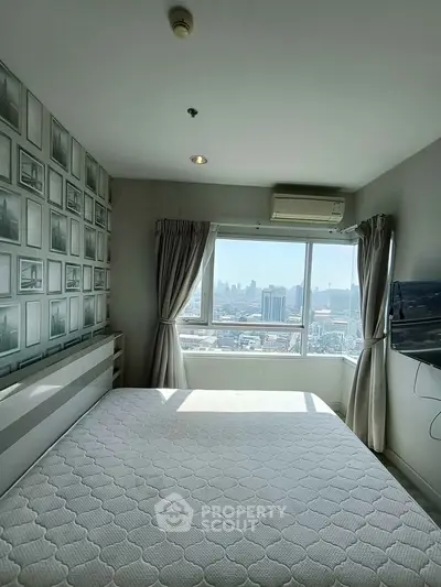 Bright bedroom with city view, featuring a large window, air conditioning, and modern decor.