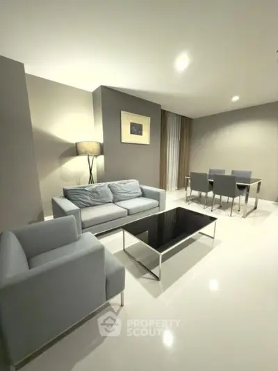 Modern living room with sleek furniture and dining area in open layout