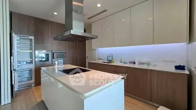 Modern kitchen with sleek cabinetry and island in luxury apartment