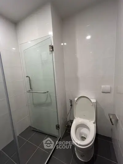 Modern bathroom with glass shower and sleek toilet design