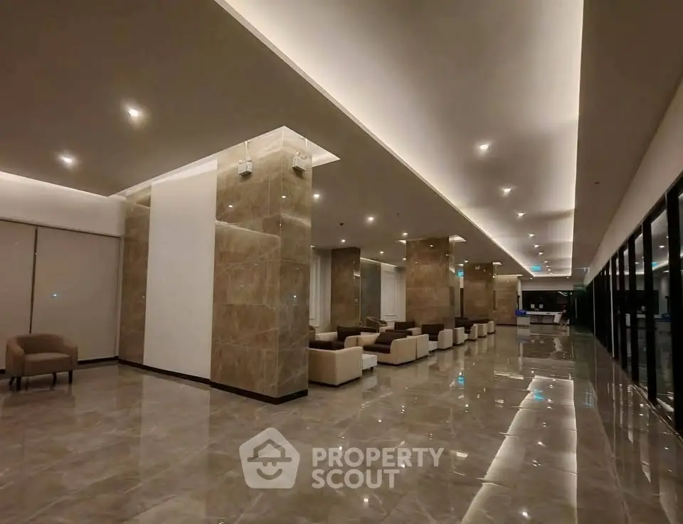 Luxurious modern lobby with elegant seating and polished marble floors in a high-end residential building.