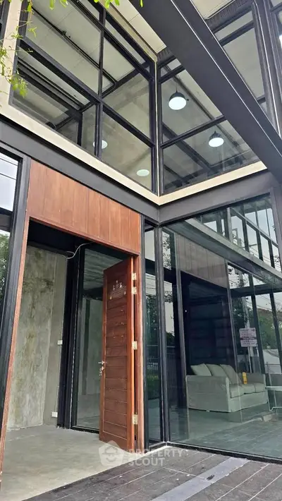 Modern architectural building with large glass windows and open entrance