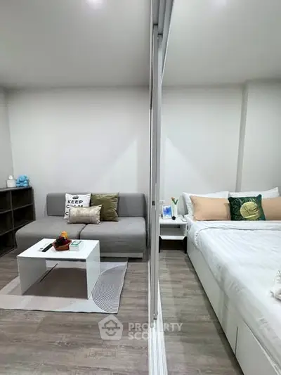 Modern studio apartment with cozy living area and comfortable bed, perfect for urban living.