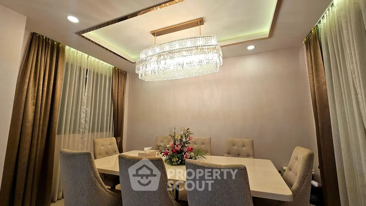 Elegant dining room with luxurious chandelier and plush seating