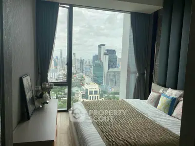 Luxurious bedroom with stunning city view in modern high-rise apartment.