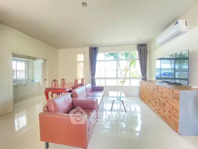 Spacious living room with modern furniture and large windows offering natural light.