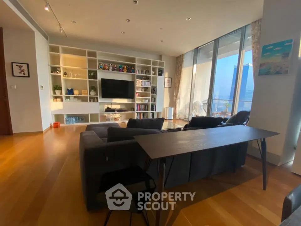 Spacious modern living room with floor-to-ceiling windows and built-in shelving.