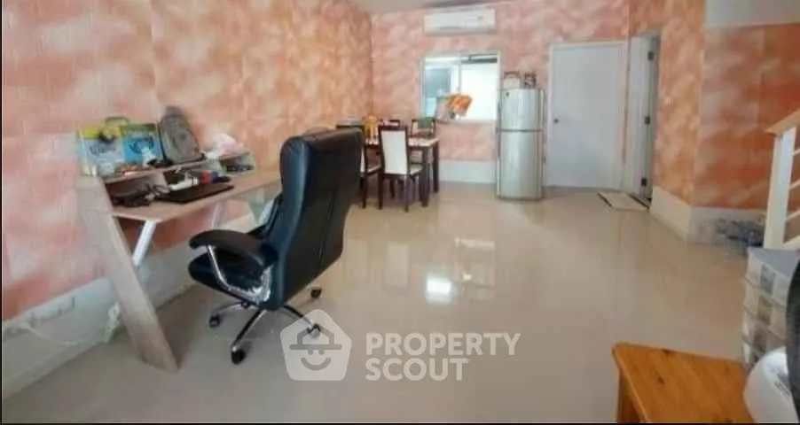Spacious living area with modern furniture and vibrant wall design