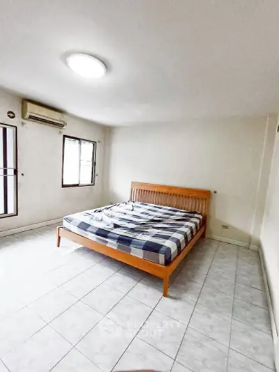 Spacious bedroom with natural light and minimalist design