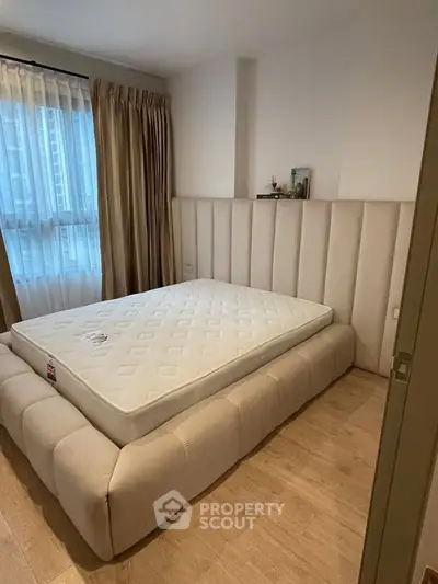 Luxurious bedroom with plush bed and elegant curtains, perfect for relaxation.