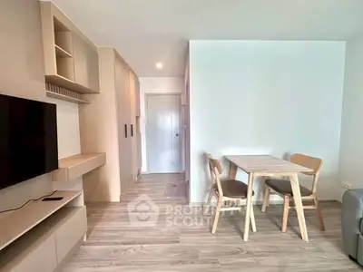 Modern living room with sleek furniture and wooden flooring in a cozy apartment.