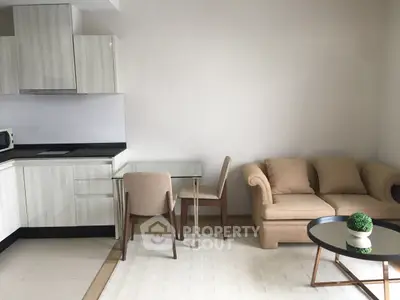 Modern living room with open kitchen and cozy seating area