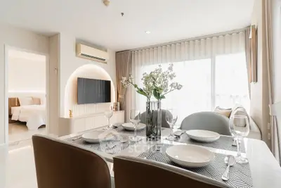 Modern open-plan living and dining area with elegant decor and natural light