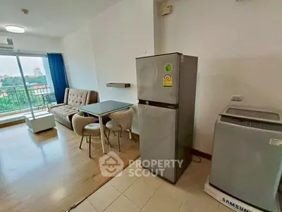 Modern living room with balcony view, featuring a sofa, dining table, fridge, and washing machine.