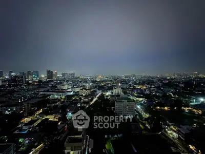 Stunning cityscape view from high-rise building at night with twinkling city lights.