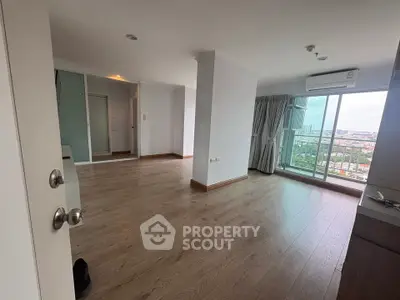 Spacious modern living room with wooden flooring and balcony view