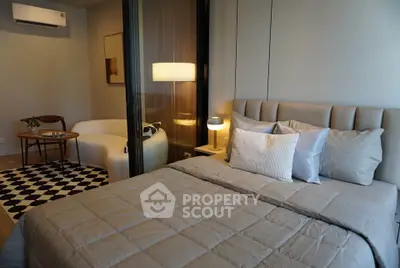 Modern bedroom with cozy seating area and stylish decor