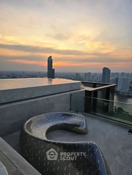 Stunning rooftop view with modern seating and city skyline at sunset.