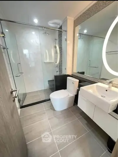 Modern bathroom with glass shower and sleek fixtures in a contemporary home.