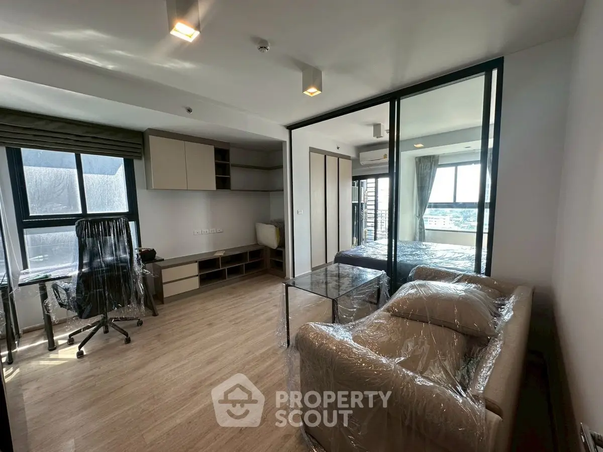 Modern living room with glass partition and natural light
