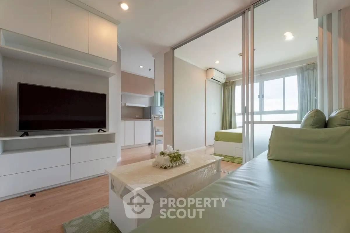 Modern living room with sleek furniture and large window for natural light.