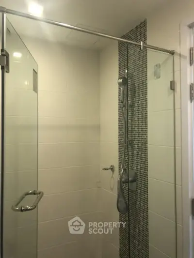 Modern bathroom with glass shower enclosure and sleek tile design
