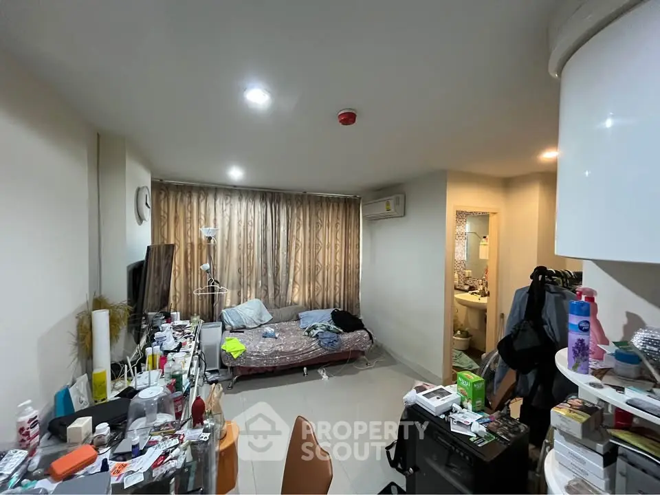 Cozy studio apartment with open layout and natural light, featuring a compact living area and modern amenities.