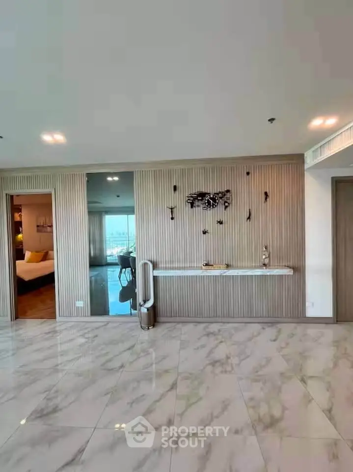 Spacious modern living room with elegant marble flooring and stylish wall decor