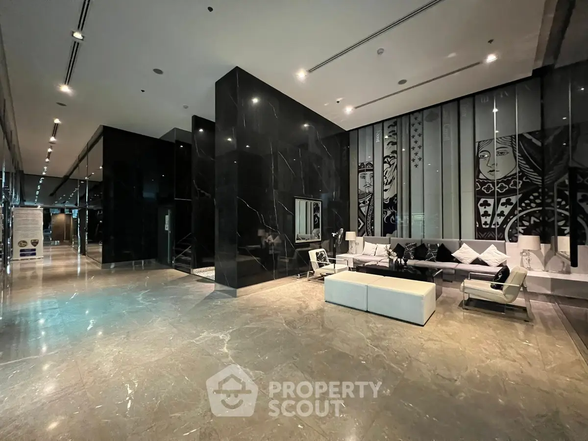Luxurious modern lobby with elegant seating and artistic wall decor in a high-end building.