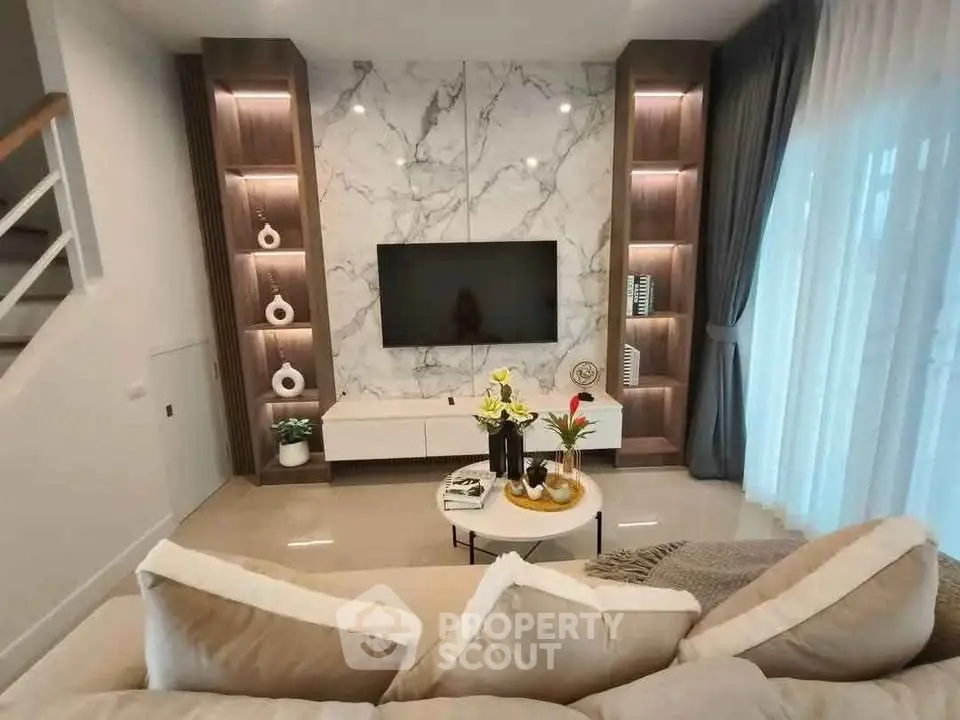 Luxurious living room with marble accent wall and modern decor