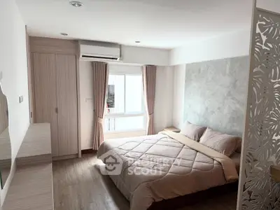 Cozy bedroom with modern decor and natural light, featuring a comfortable bed and stylish wardrobe.