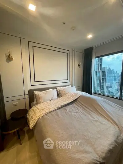 Modern bedroom with city view and stylish decor in high-rise apartment